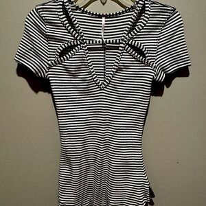 Black and white stripe Free People pullover shirt with cutouts.